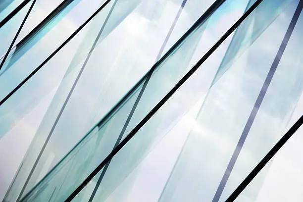 Photo of Glass architecture. Double-exposure tilt photo of contemporary office building facade.