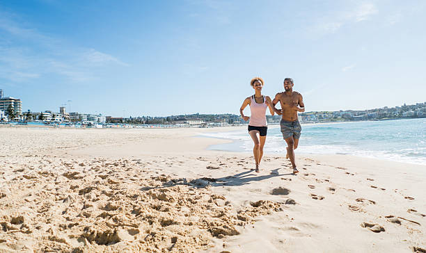 istock Australian couple running at the beach 505942344