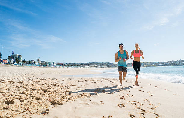 Young couple running at the beach