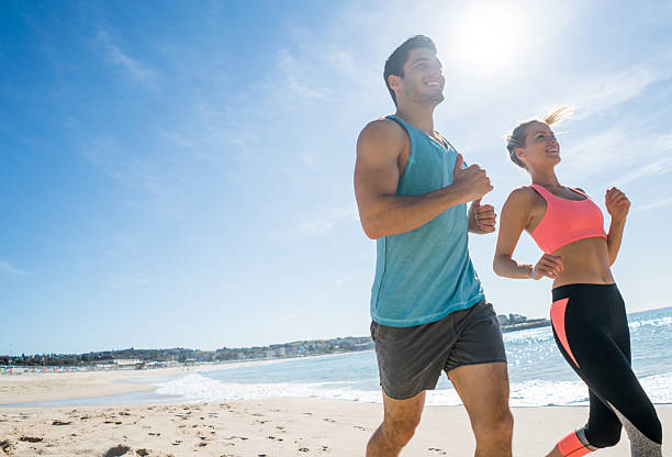 istock Fit couple running at the beach 505942512