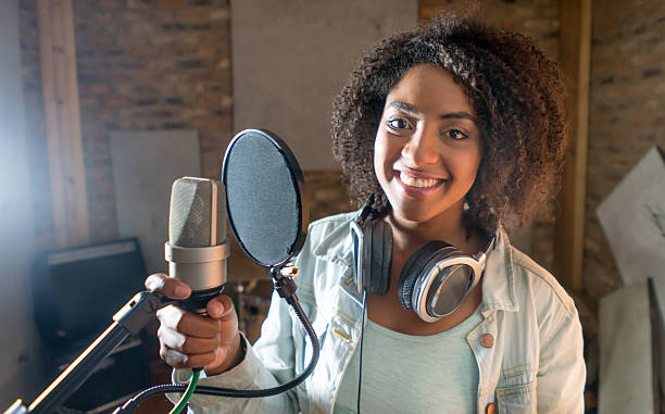 istock Happy female singer at a recording studio 505942696