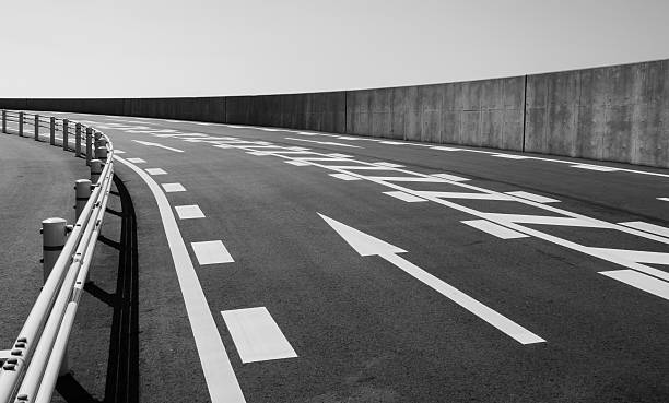 Concrete road with arrow symbol in black and white