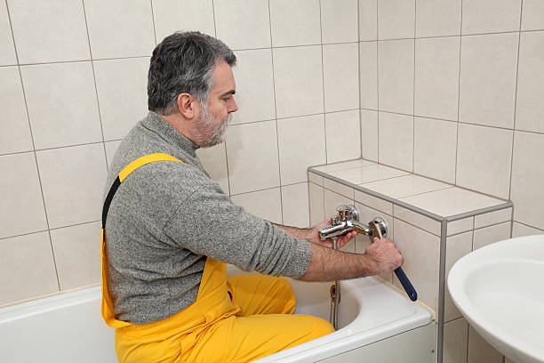 istock Plumber works in a bathroom bath toob faucet fixing 505943766