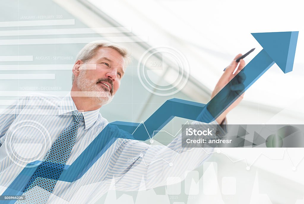 Business man drawing a growth graph Business man drawing a growth graph with an arrow pointing up Growth Stock Photo