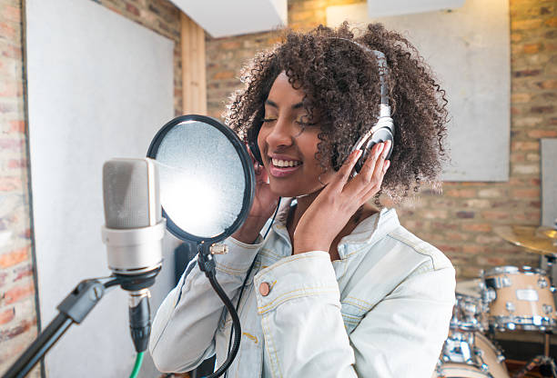 istock Woman singing at a recording studio 505945240