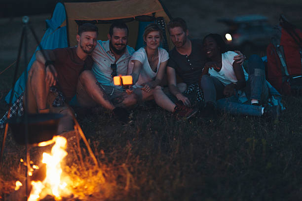 istock Friends camping together in nature 505945360