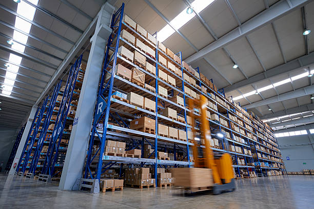 istock Forklifts carrying cardboard box in warehouse. 505946710