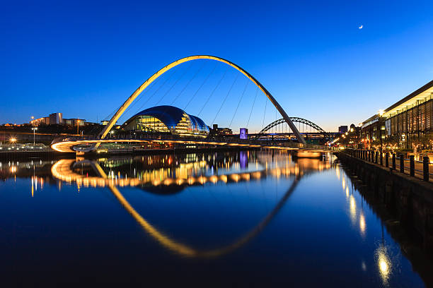 Gateshead Moonlit Evening The image shows the Gateshead Millenium Bridge on a moonlit evening.  In the background are the Sage and the Tyne Bridge. northeastern england stock pictures, royalty-free photos & images