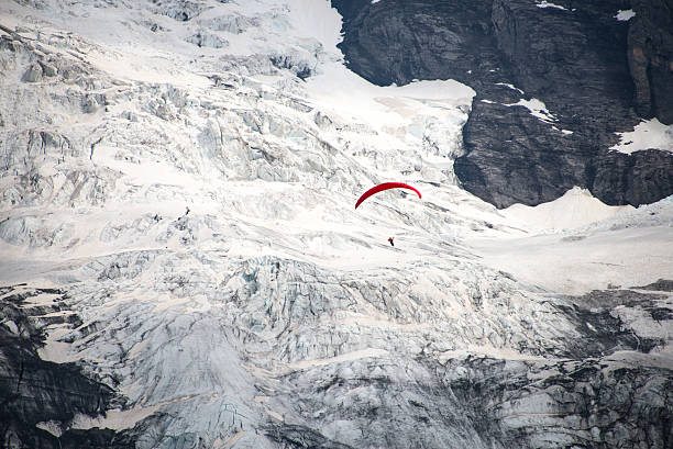 istock paragliding is over the glacier 505949549