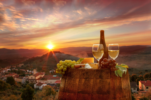 White wine with barrel on vineyard in Chianti, Tuscany, Italy