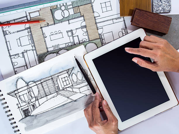 istock Hands holding tablet with architecture drawing, home renovation concept 505951899