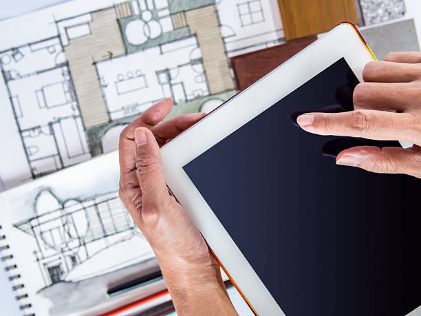 istock Hands holding tablet with architecture drawing, home renovation concept 505951903