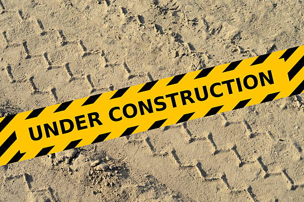istock Tire track in a sand with under construction yellow tape 505953523