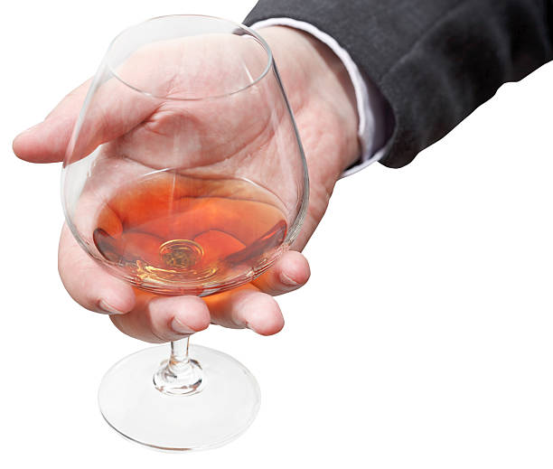 istock cognac glass in businessman hand 505956273