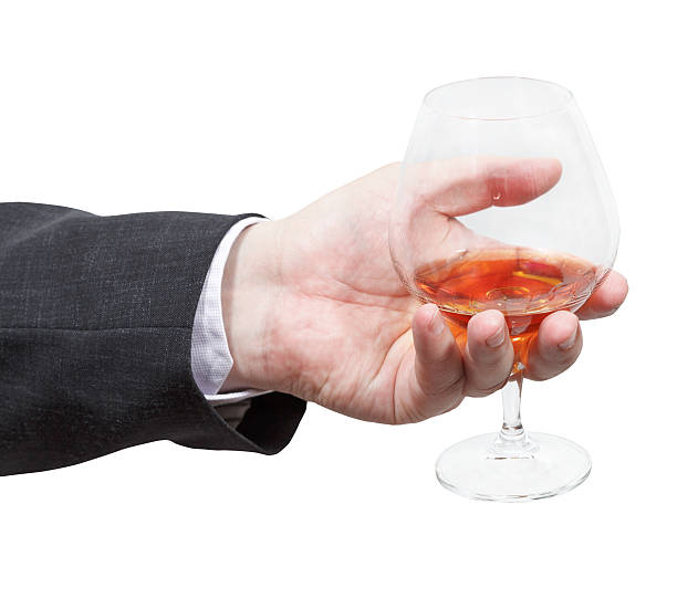 istock brandy glass in businessman hand 505956277