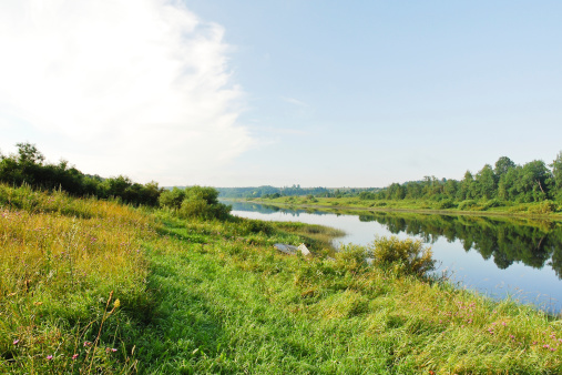 green riverside of small river in summer day, Russia