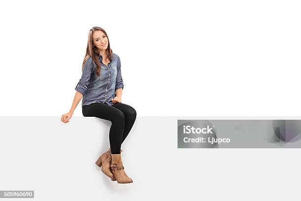 Beautiful Brunette Woman Sitting On A Panel Stock Photo - Download Image Now - Sitting, Women, Cut Out