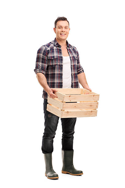 istock Farmer holding an empty wooden crate 505961554
