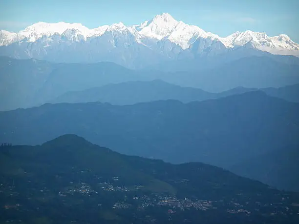 The Kanchenjunga (in the Himalayas) is the third highest mountain in the world with an elevation of 8,586 m (28,169 ft) and lies partly in Nepal and partly in Sikkim, India.
