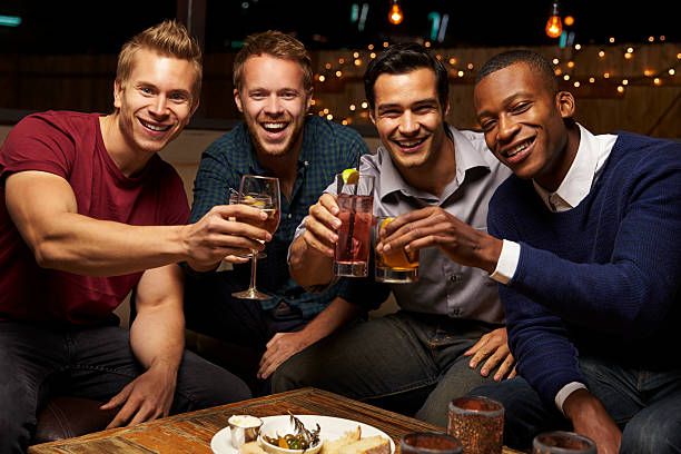 Portrait Of Male Friends Enjoying Night Out At Rooftop Bar Portrait Of Male Friends Enjoying Night Out At Rooftop Bar stag night stock pictures, royalty-free photos & images