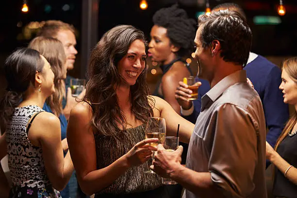 Photo of Couples Dancing And Drinking At Evening Party