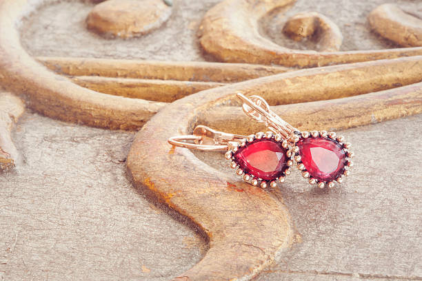 Beautiful shiny earrings hanging on the vintage background