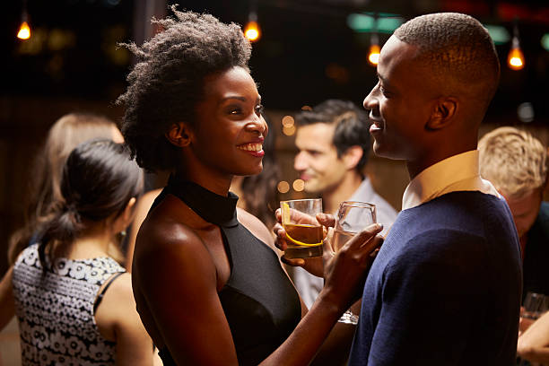 Couples Dancing And Drinking At Evening Party Couples Dancing And Drinking At Evening Party black people bar stock pictures, royalty-free photos & images