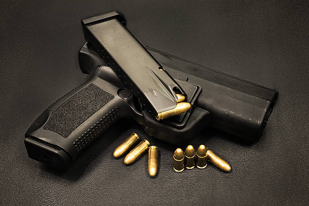 istock handgun on the black background 505964692