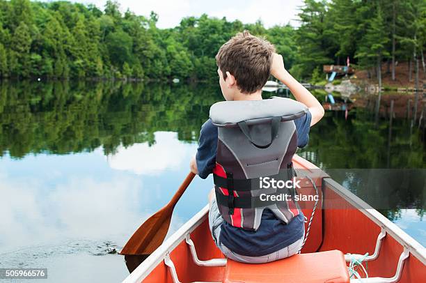 Boy In A Canoe Stock Photo - Download Image Now - Child, Camping, Canoe