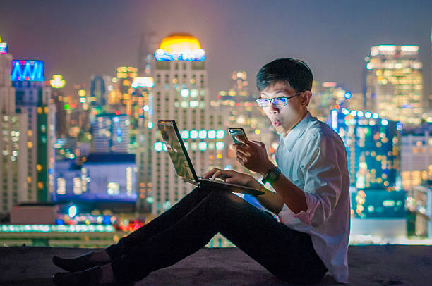 istock Businessman using a laptop on the rooftop of a skyscraper 505967456