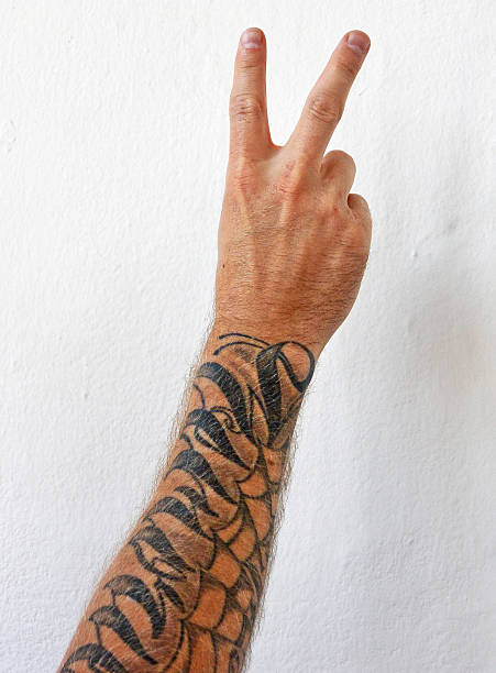 A cropped shot of a tattooed hand