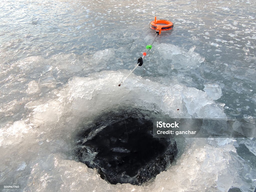 Winter fishing from the ice Winter fishing from ice on a fishing tackle in Russia Adult Stock Photo