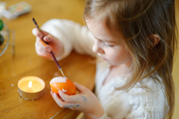 istock Adorable little girl coloring an Easter egg 505968364