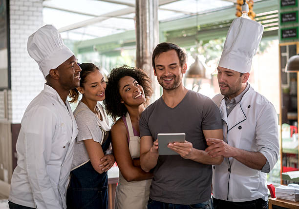 istock People working at a restaurant and checking a review 505968468