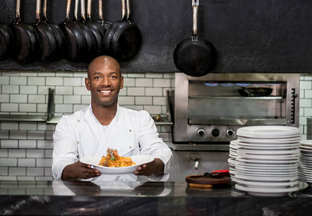 istock Chef working in a kitchen and showing his plate 505969086
