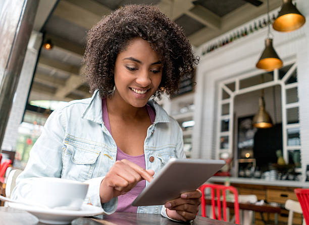 istock Woman using free wifi at a restaurant 505969286
