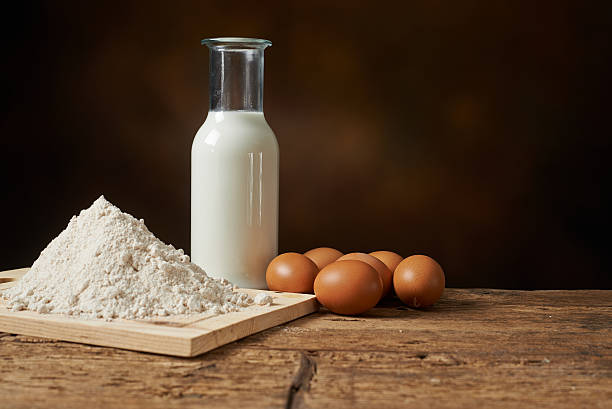istock manufacturing materials, flour eggs and milk on a wooden kitchen 505972262