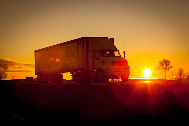 istock Tractor trailer at sunrise on the highway 505972540