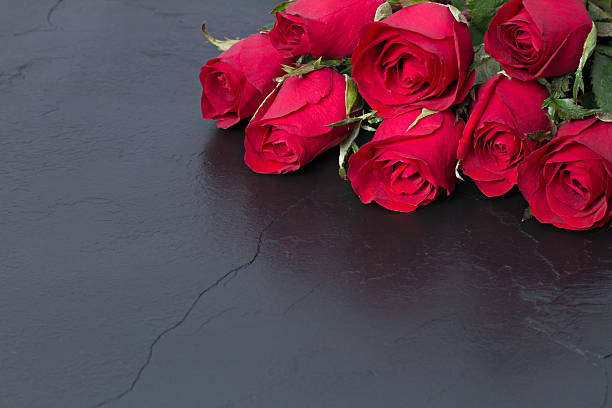 istock Red roses on woonden background. Valentine's day background. 505973714
