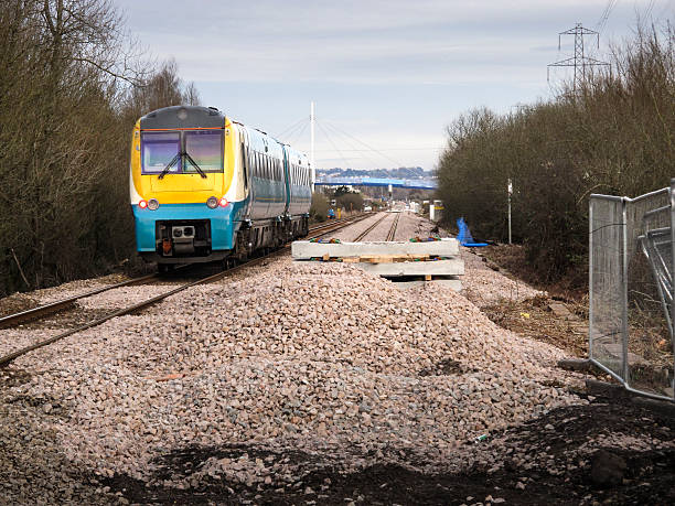istock Passenger train passing new track laying site 505975707
