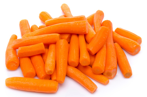 Heap of fresh peeled carrots, isolated on white