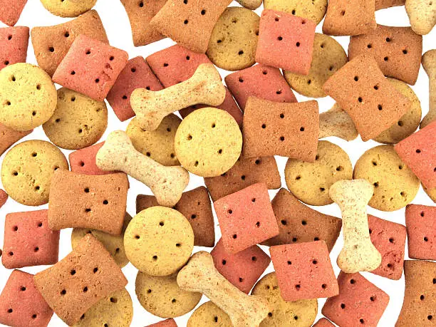 Close up of assorted shaped dog biscuits on a white background.
