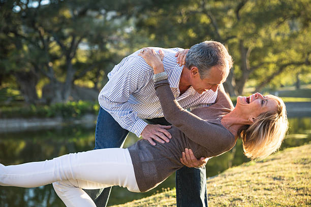 Their love keeps them young at heart! Happy mature couple dancing dip stock pictures, royalty-free photos & images