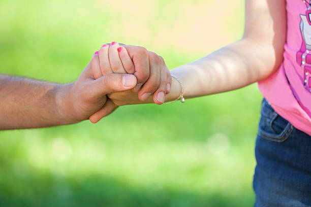 istock father holding daughter hand 505980557