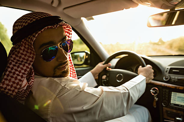 arabian in auto - car driving businessman hands free device foto e immagini stock