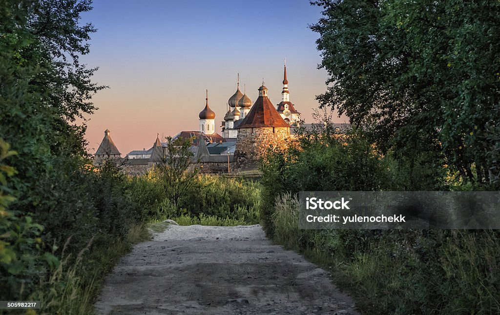 Crouching sunset Bright from sunset rays monastery of the dark thickets of the forest Solovetsky Islands Stock Photo