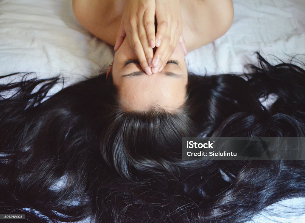 Pretty Messy Hair Young woman with long black messy hair. Black Hair Stock Photo