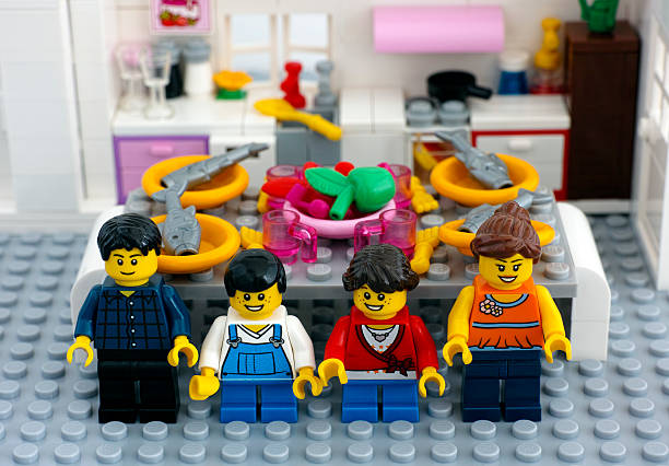 Tambov, Russian Federation - August 29, 2015: Lego family in domestic kitchen with table ready for dinner. Custom set. Studio shot.