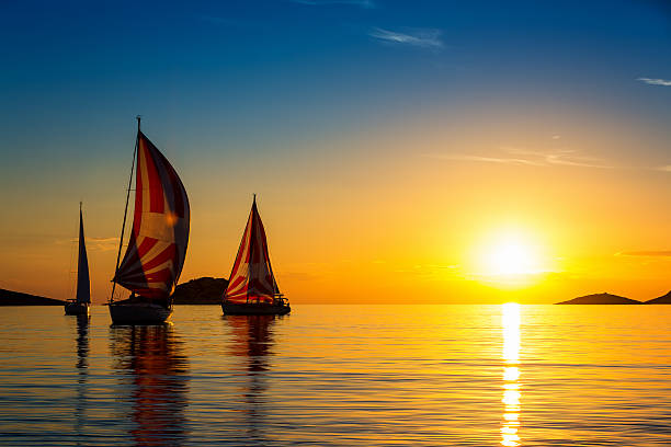 veleros formación en la puesta de sol - kornati fotografías e imágenes de stock