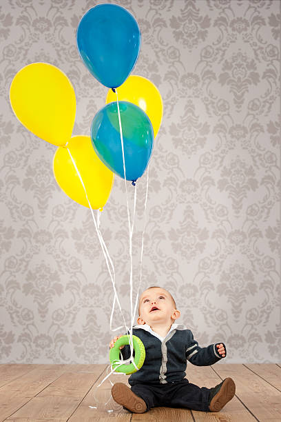 istock baby boy with balloons 505990686
